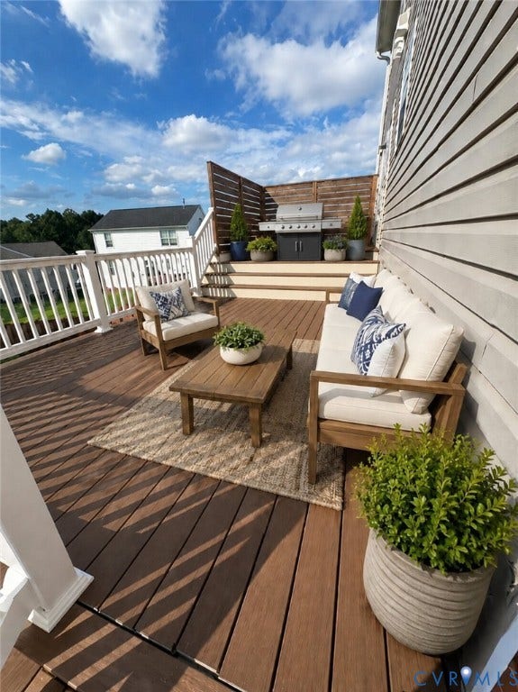 Multi-level deck featuring Trex flooring, white railings, and slatted privacy screening. *Virtually enhanced