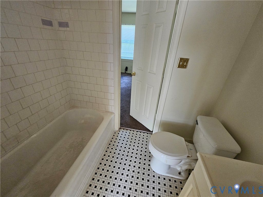 1711 Halifax Avenue, Richmond, VA 23224 White subway tile surround, white bathtub, black and white geometric floor tiling, and a white toilet