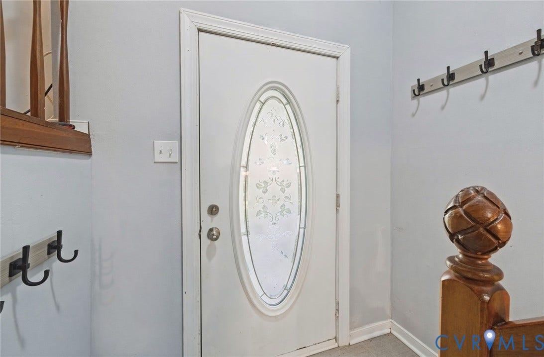 2709 Sutters Mill Court, Midlothian, VA 23112 Entry door with decorative oval glass insert, a coat rack with multiple hooks, and a wood newel post