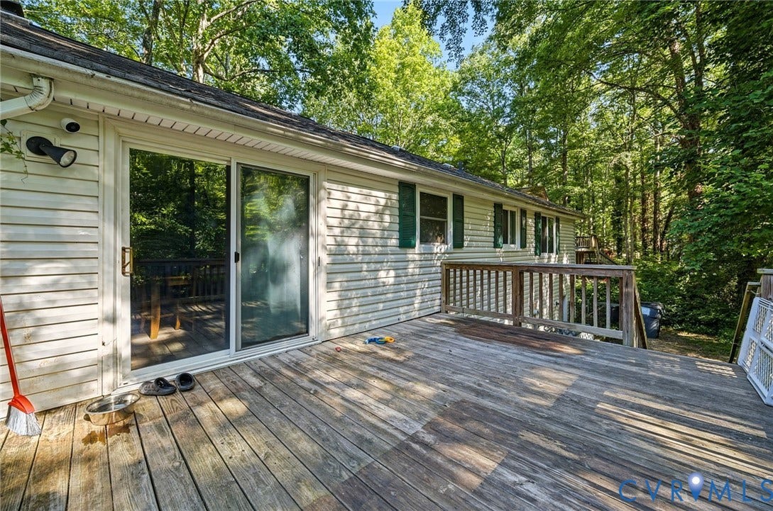 2709 Sutters Mill Court, Midlothian, VA 23112 Expansive exterior deck featuring a wooden railing and mature trees