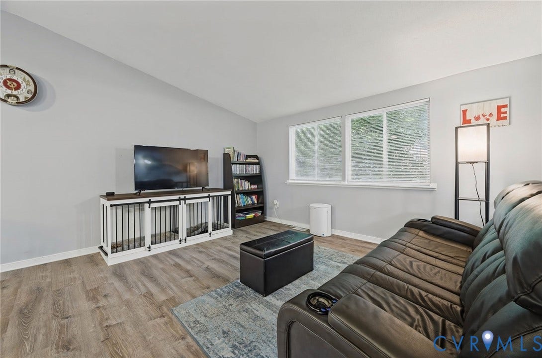 2709 Sutters Mill Court, Midlothian, VA 23112 Vaulted ceiling, wood-finish flooring, light gray wall color, multiple large windows, and built-in shelving