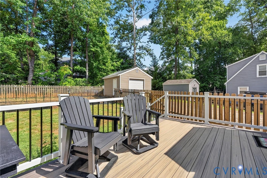 7248 Full Rack Drive, Midlothian, VA 23112 Composite deck with white railings and black balusters, featuring a detached garage, shed, and wood fencing