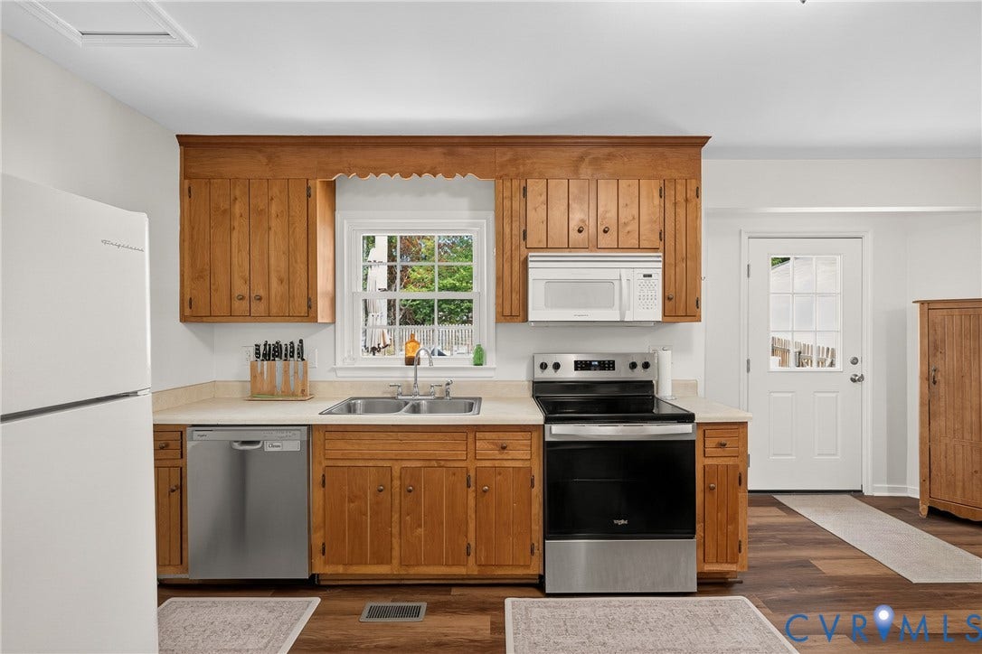 7248 Full Rack Drive, Midlothian, VA 23112 Kitchen featuring wood cabinetry, a double basin sink, a white built-in microwave, and a stainless steel electric range