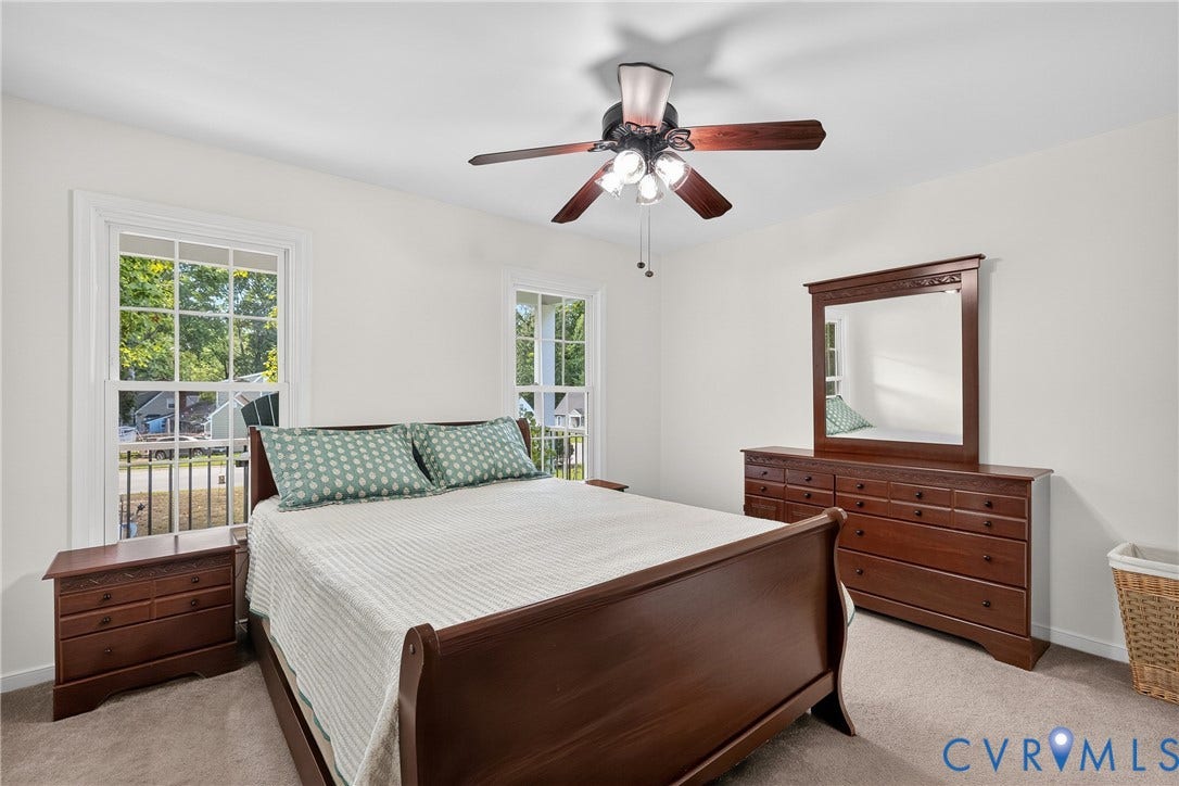 7248 Full Rack Drive, Midlothian, VA 23112 Neutral wall color, two large windows with white trim, ceiling fan with light fixture, and carpeted flooring