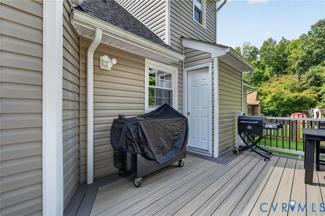 7248 Full Rack Drive, Midlothian, VA 23112 Composite deck flooring with integrated railing system, leading to a utility door with a protective awning, all set against horizontal siding