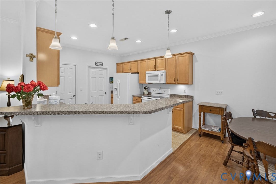 11116 Lantern Way, North Chesterfield, VA 23236 Kitchen featuring wood-finish flooring, recessed lighting, pendant lighting, light wood cabinetry, and a countertop with an overhang