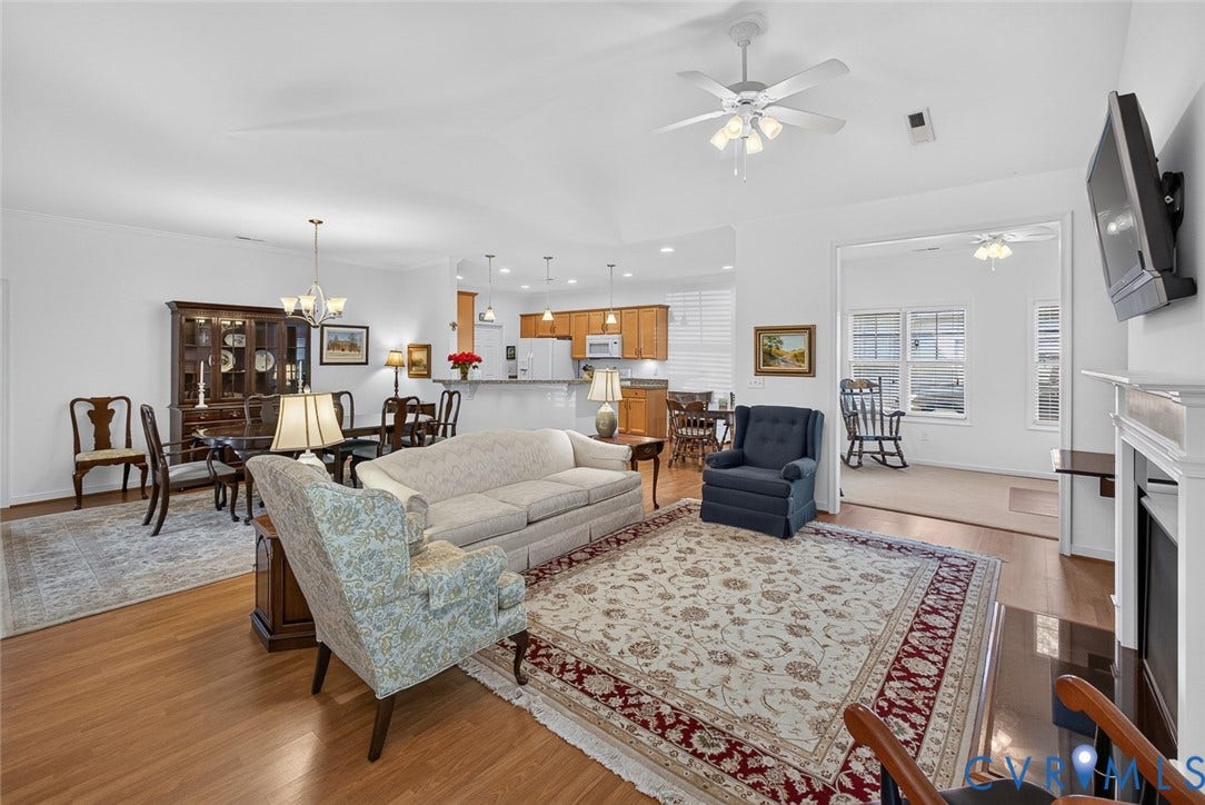 11116 Lantern Way, North Chesterfield, VA 23236 Open-concept living space featuring wood-finish flooring, a white mantel, and ceiling fans