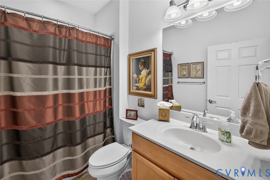 11116 Lantern Way, North Chesterfield, VA 23236 Vanity with a single basin sink, chrome faucet, wood-finish cabinetry, and overhead light fixture