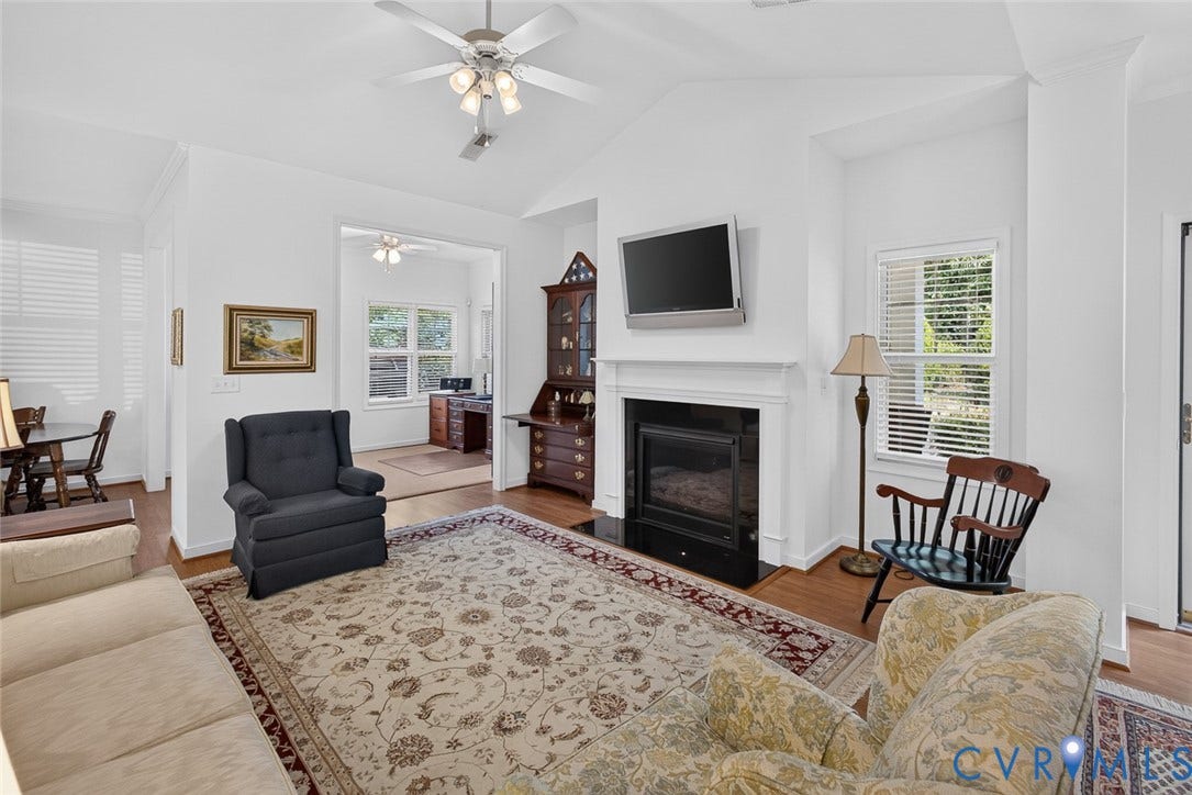 11116 Lantern Way, North Chesterfield, VA 23236 Vaulted ceiling with a ceiling fan, fireplace with a white mantel, wood-finish flooring, and white window blinds