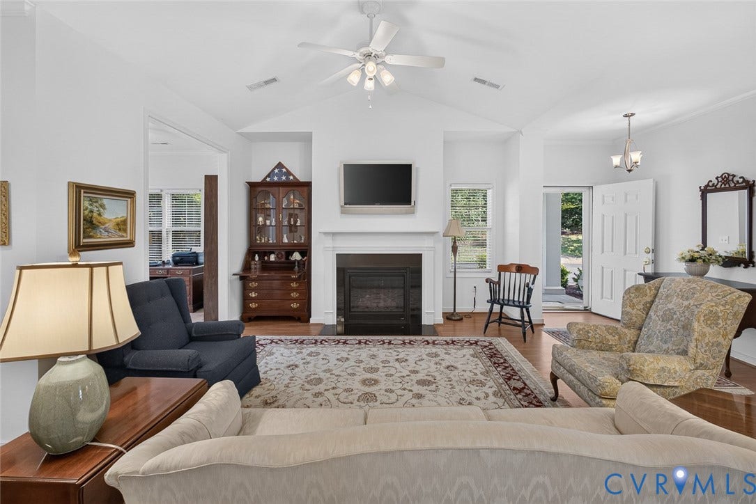 11116 Lantern Way, North Chesterfield, VA 23236 Vaulted ceiling with a ceiling fan, fireplace with a white mantel, wood-finish flooring, and white paneled entry door