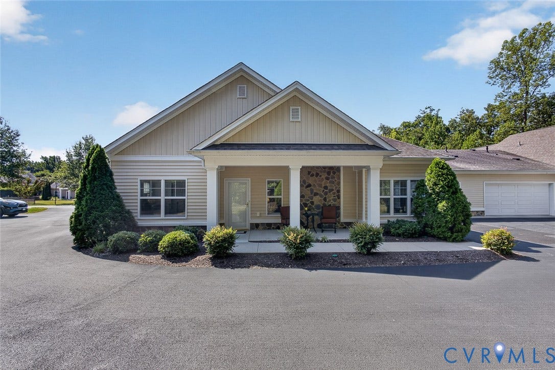 11116 Lantern Way, North Chesterfield, VA 23236 Exterior featuring horizontal siding, a covered entry with stone column accents, an attached garage, and surrounding mature landscaping