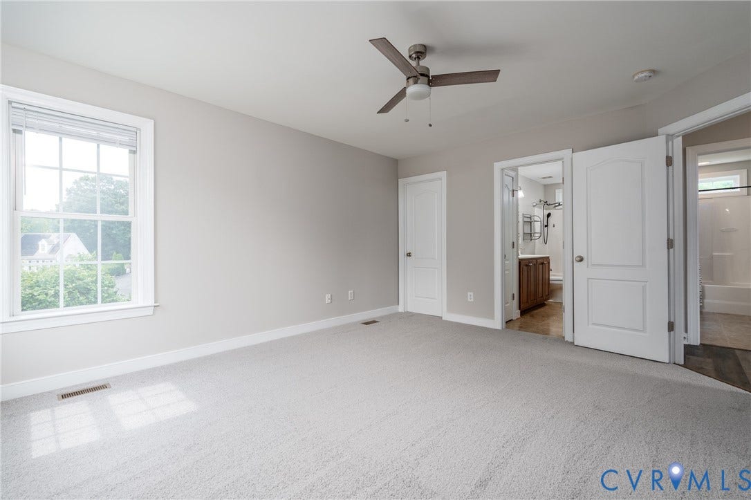 Plush carpeting, neutral wall color, contemporary ceiling fan, white trim, and a window with blinds