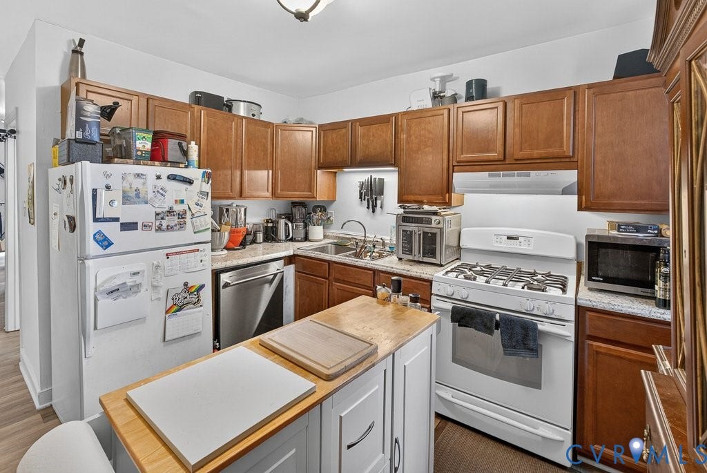 1826 Idlewood Avenue, Randolph, Richmond, VA 23220 Kitchen with wood-finish cabinetry, light-toned countertops, and a central island with a wood-finish top
