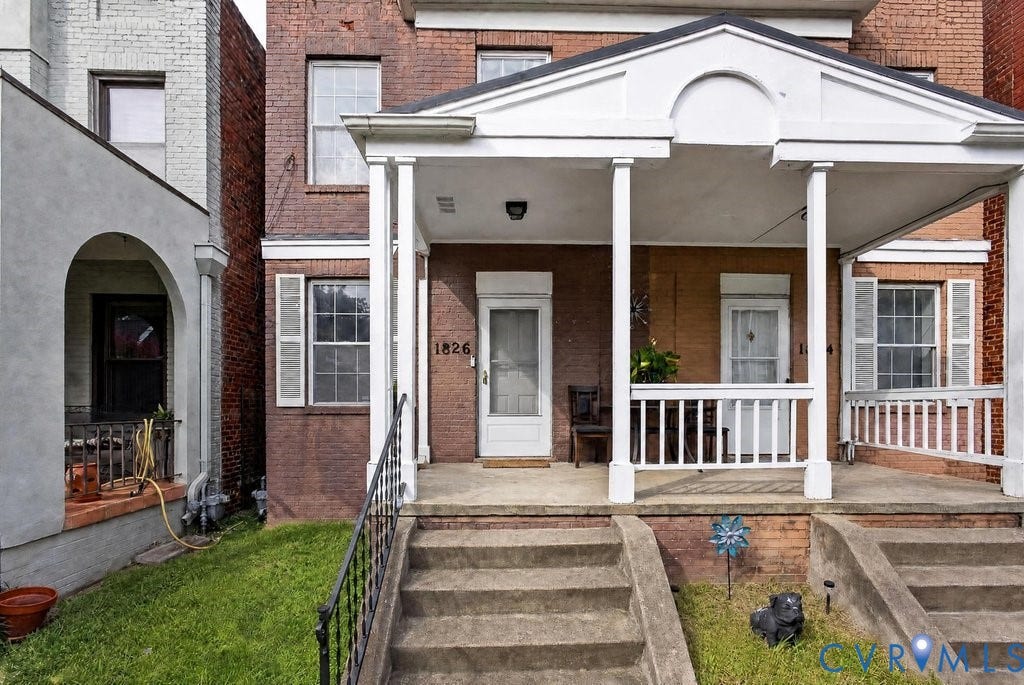 1826 Idlewood Avenue, Randolph, Richmond, VA 23220 Brick exterior with a white portico, concrete steps, and a wrought iron handrail
