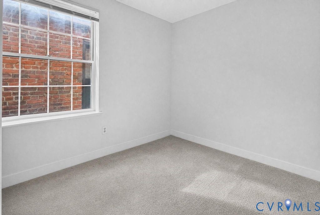 1826 Idlewood Avenue, Randolph, Richmond, VA 23220 Light gray wall paint with white trim, gray carpet flooring, and a multi-pane window