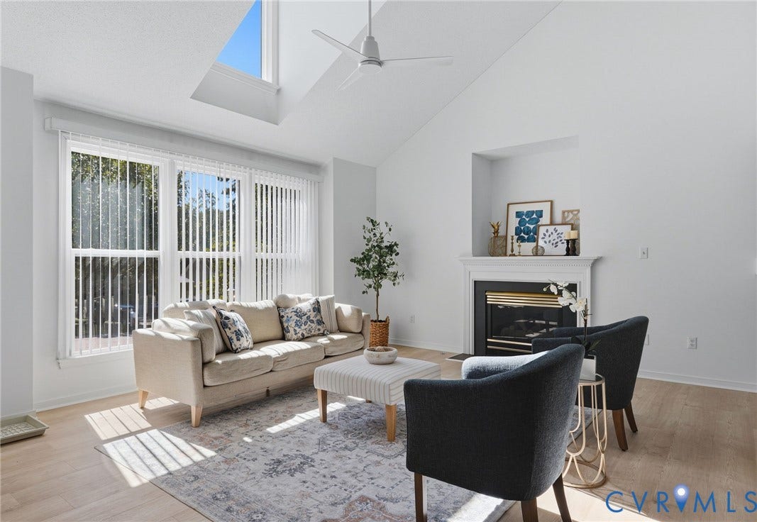 Soaring ceilings, a gas fireplace, new blinds, new ceiling light, and new paint make this entire home exhale with a fresh new look.