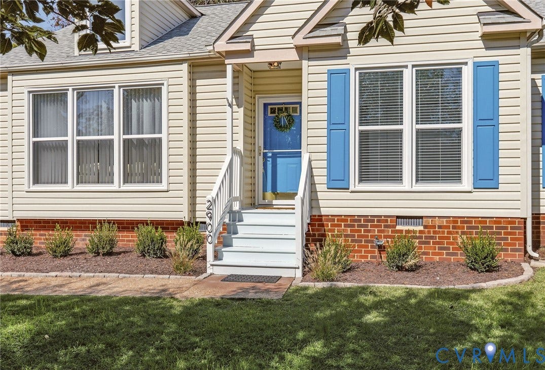 Welcoming entry with new porch lights, address numbers, and landscape plantings.
