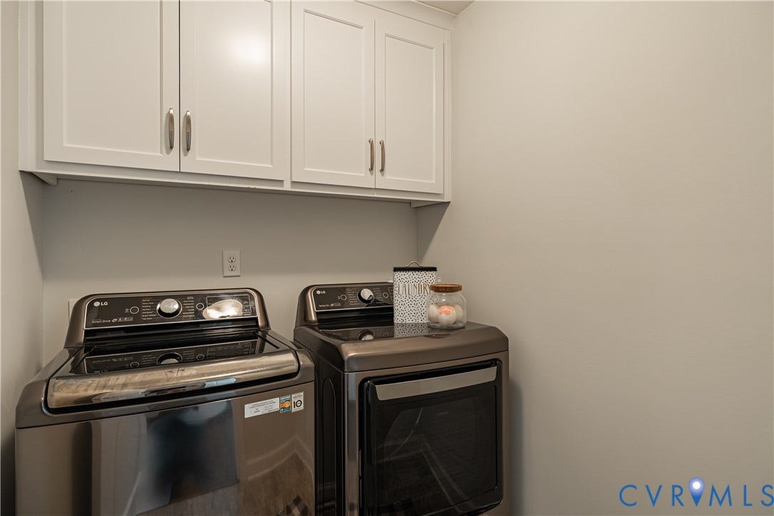 White shaker-style upper cabinetry with silver hardware