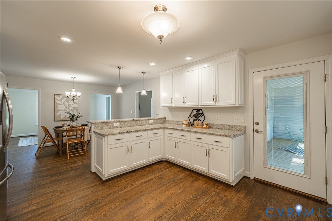 Kitchen featuring white shaker-style cabinetry, light-toned countertops, pendant lighting, recessed lighting, and wood-finish flooring