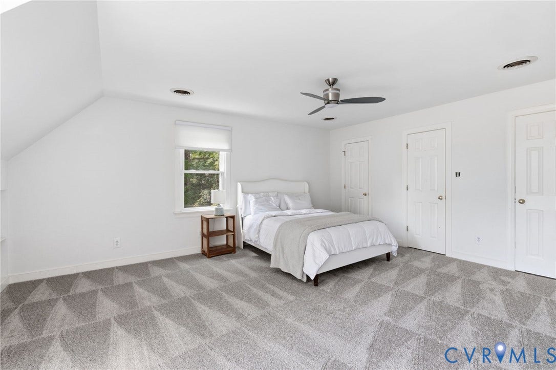 Patterned carpet, white walls, recessed lighting, ceiling fan, and multiple white panel doors