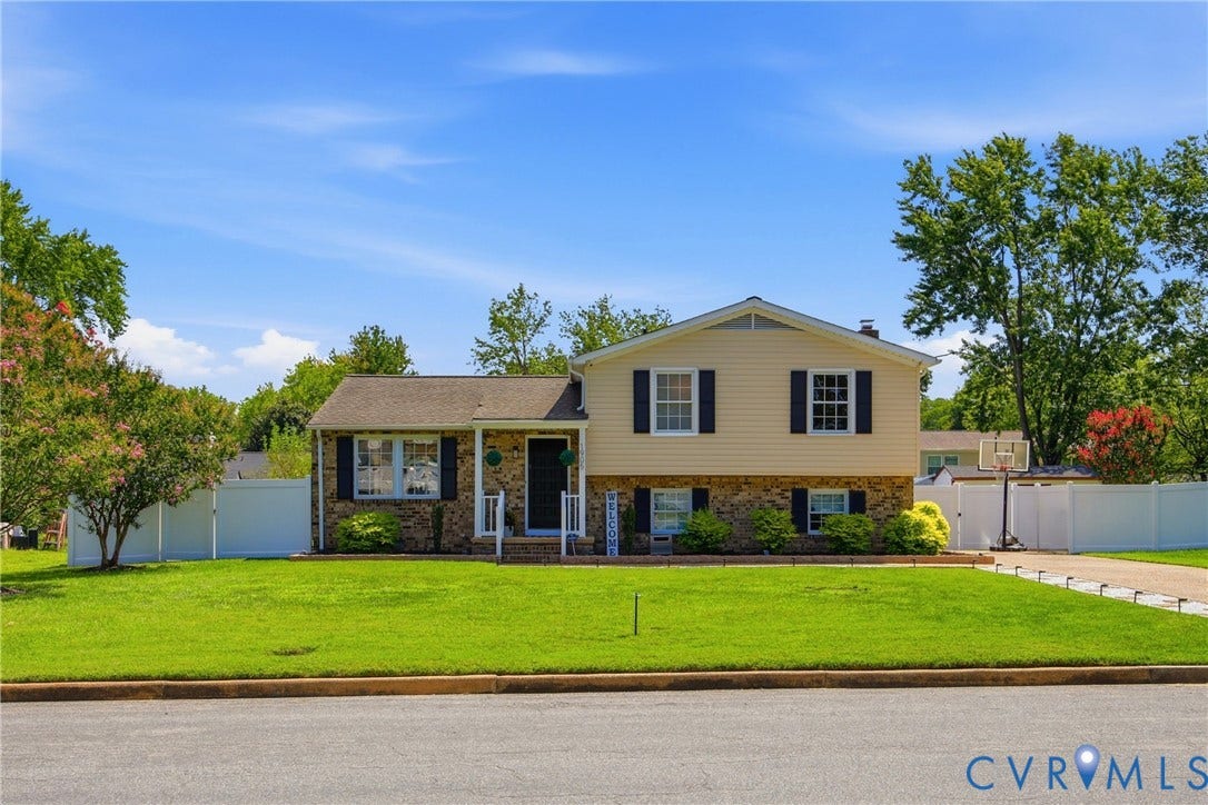 1905 Reagan Road, Henrico, VA 23228 Split-level residence featuring a brick and siding exterior, front porch, mature landscaping, and an extended driveway