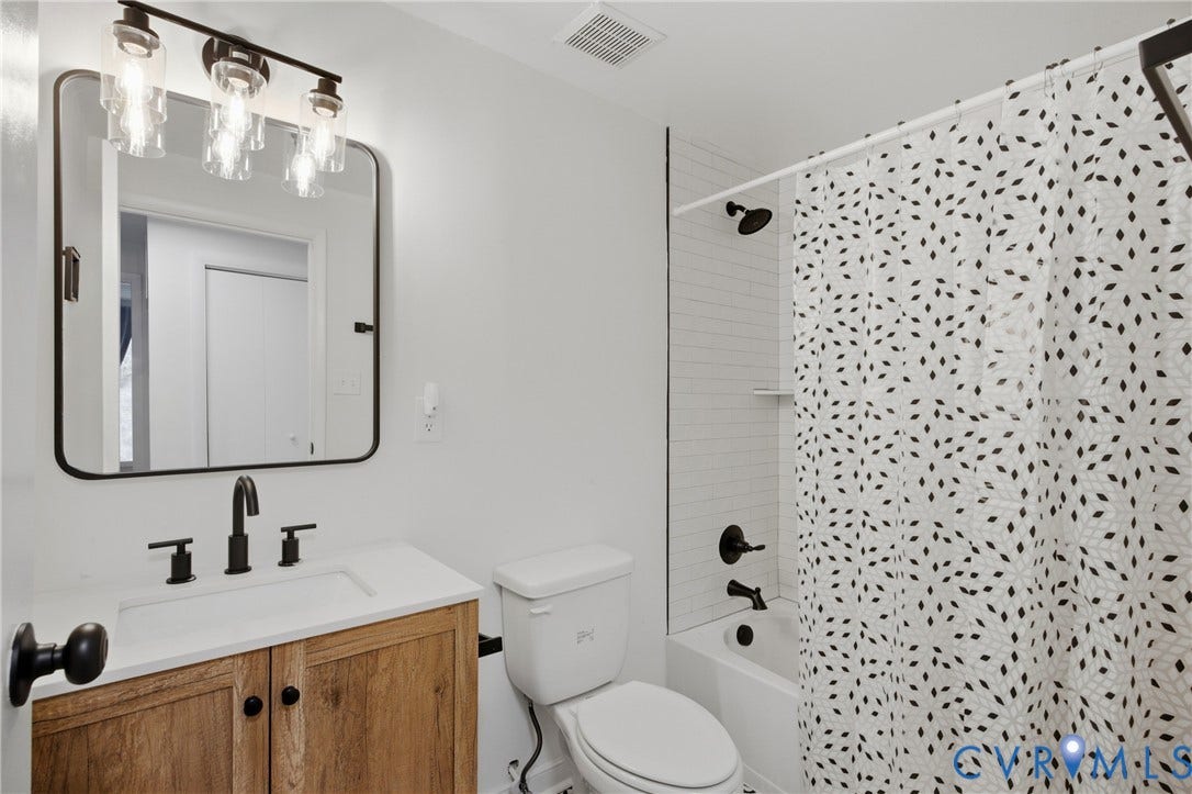1905 Reagan Road, Henrico, VA 23228 White vanity countertop with integrated sink and matte black faucet