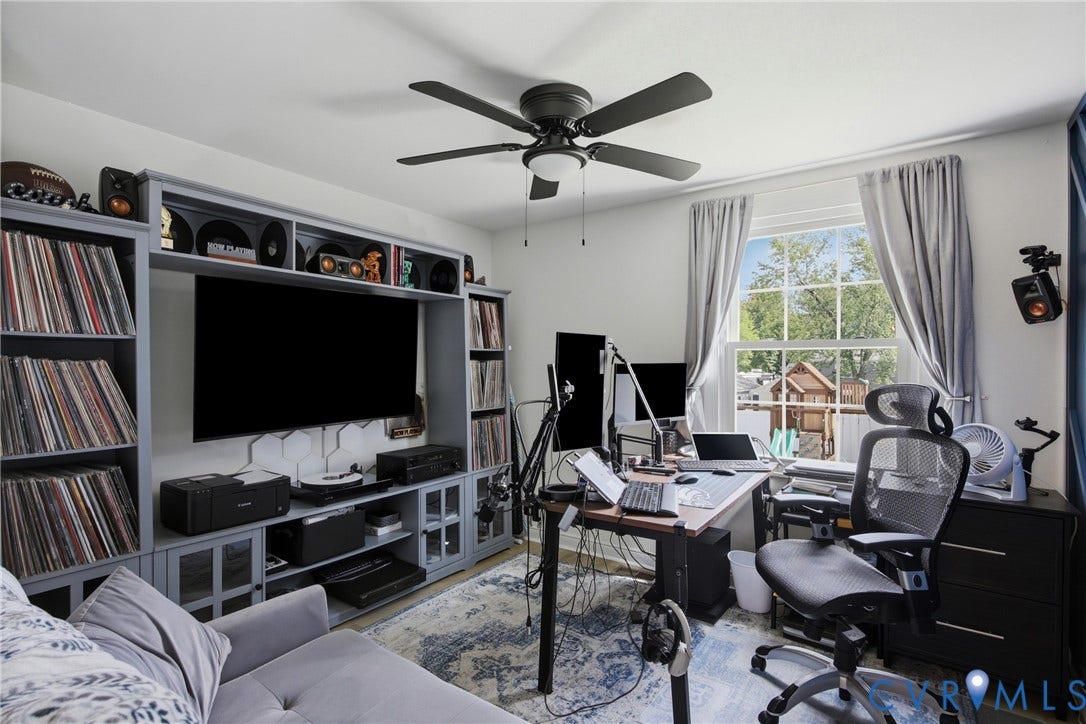 1905 Reagan Road, Henrico, VA 23228 Built-in media console with open shelving, ceiling fan, large window, and light-toned walls