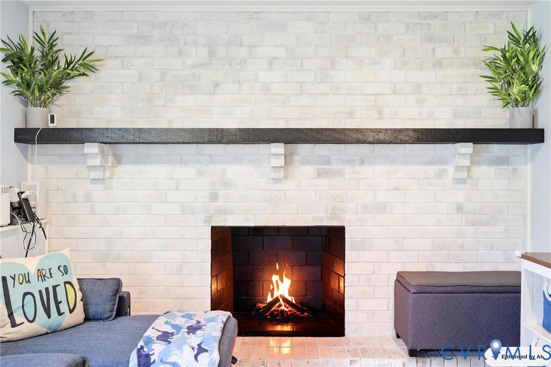1905 Reagan Road, Henrico, VA 23228 White-painted brick fireplace featuring a dark wood mantle