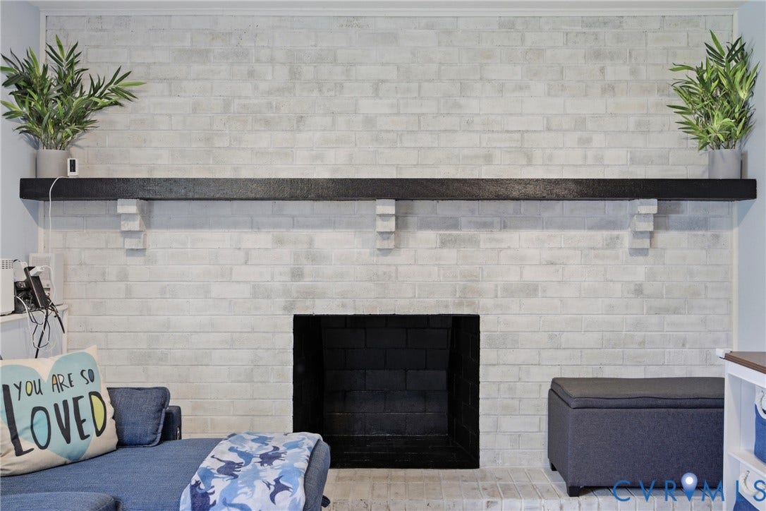 1905 Reagan Road, Henrico, VA 23228 White-washed brick fireplace with a black mantel