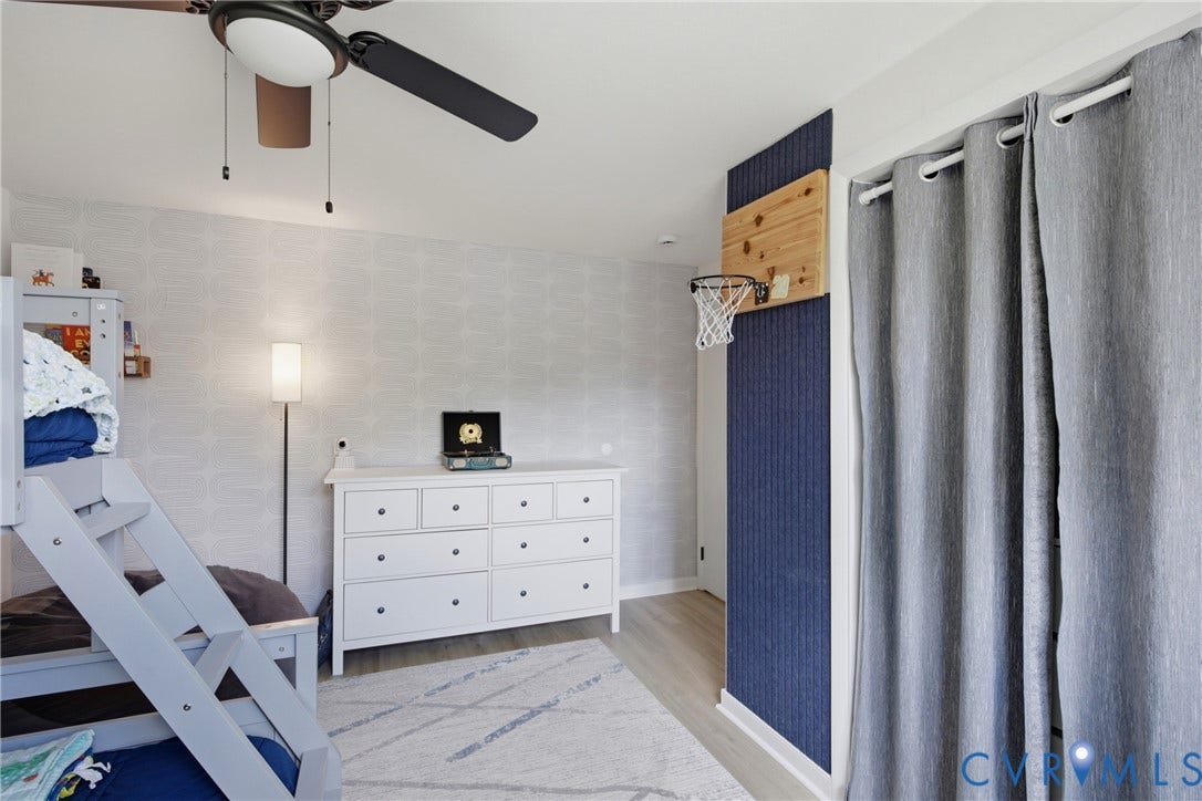 1905 Reagan Road, Henrico, VA 23228 Ceiling fan with integrated lighting, wood-finish flooring, accent wall, light-toned wall covering, and a white dresser with dark hardware