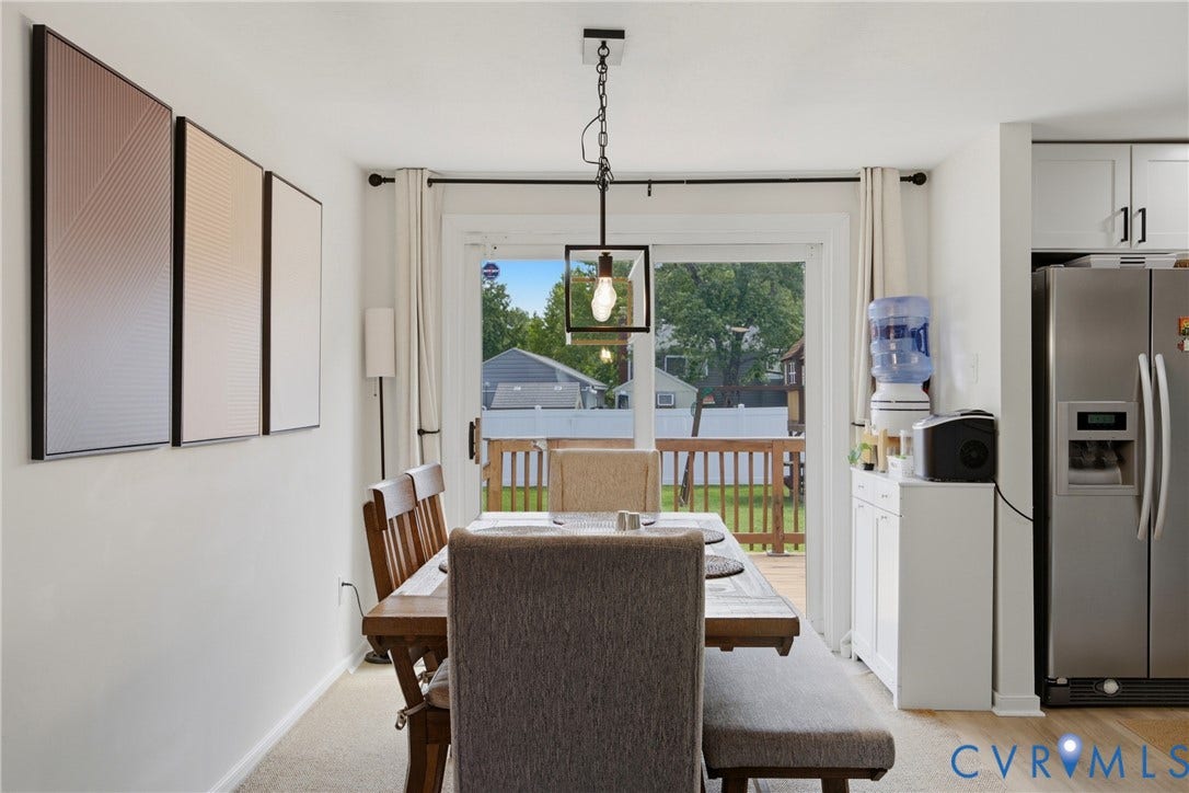 1905 Reagan Road, Henrico, VA 23228 Dining area with wood-finish flooring, a contemporary pendant light fixture, and a sliding glass door providing access to an exterior deck