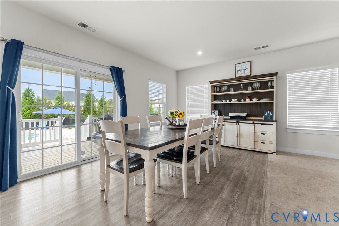 11707 Amara Drive, Chester / Highlands Golf Club, Chesterfield, VA 23838 Sliding glass doors opening to an outdoor deck, recessed ceiling lighting, wood-finish flooring, and built-in shelving with lower cabinetry