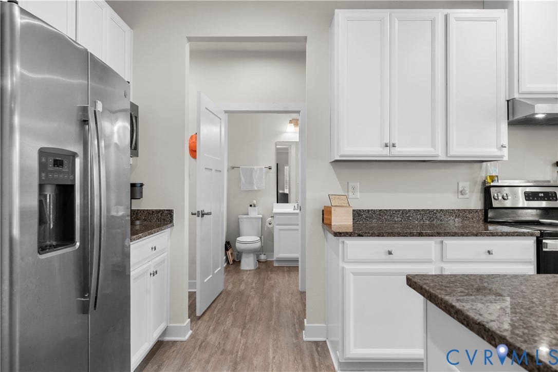11707 Amara Drive, Chester / Highlands Golf Club, Chesterfield, VA 23838 White cabinetry with dark countertops, stainless steel refrigerator, and wood-finish flooring