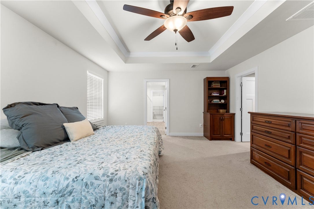 11707 Amara Drive, Chester / Highlands Golf Club, Chesterfield, VA 23838 Tray ceiling with central ceiling fan, window with blinds, and neutral carpet flooring