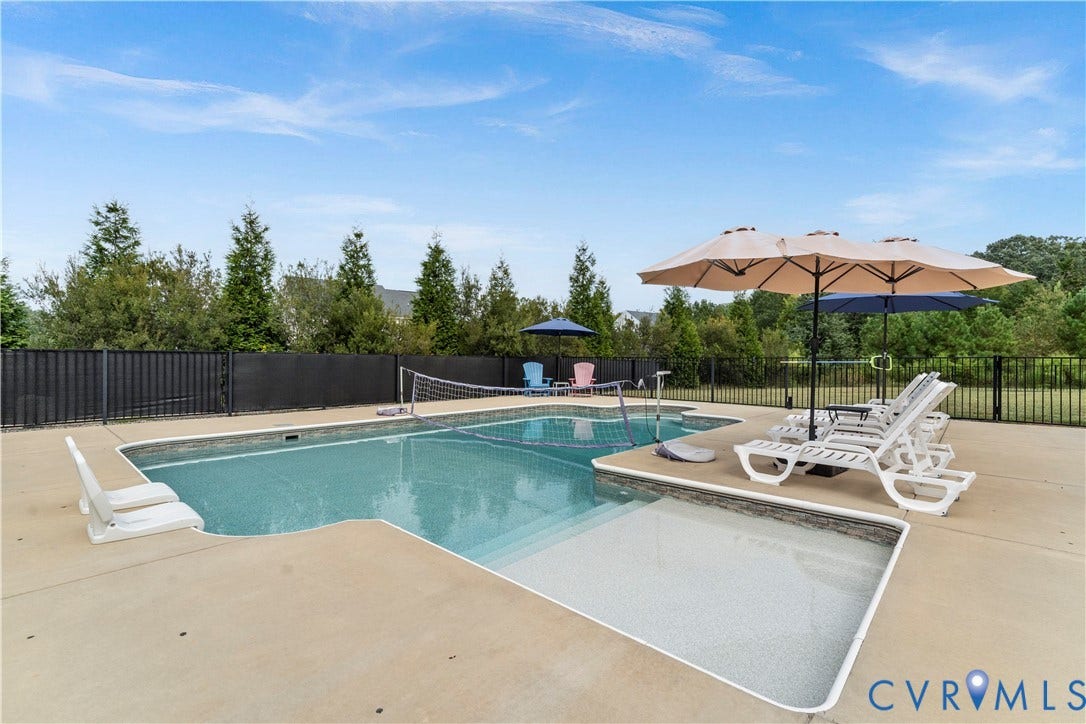 11707 Amara Drive, Chester / Highlands Golf Club, Chesterfield, VA 23838 Lagoon-style swimming pool with an integrated shallow sun shelf, surrounded by a concrete deck