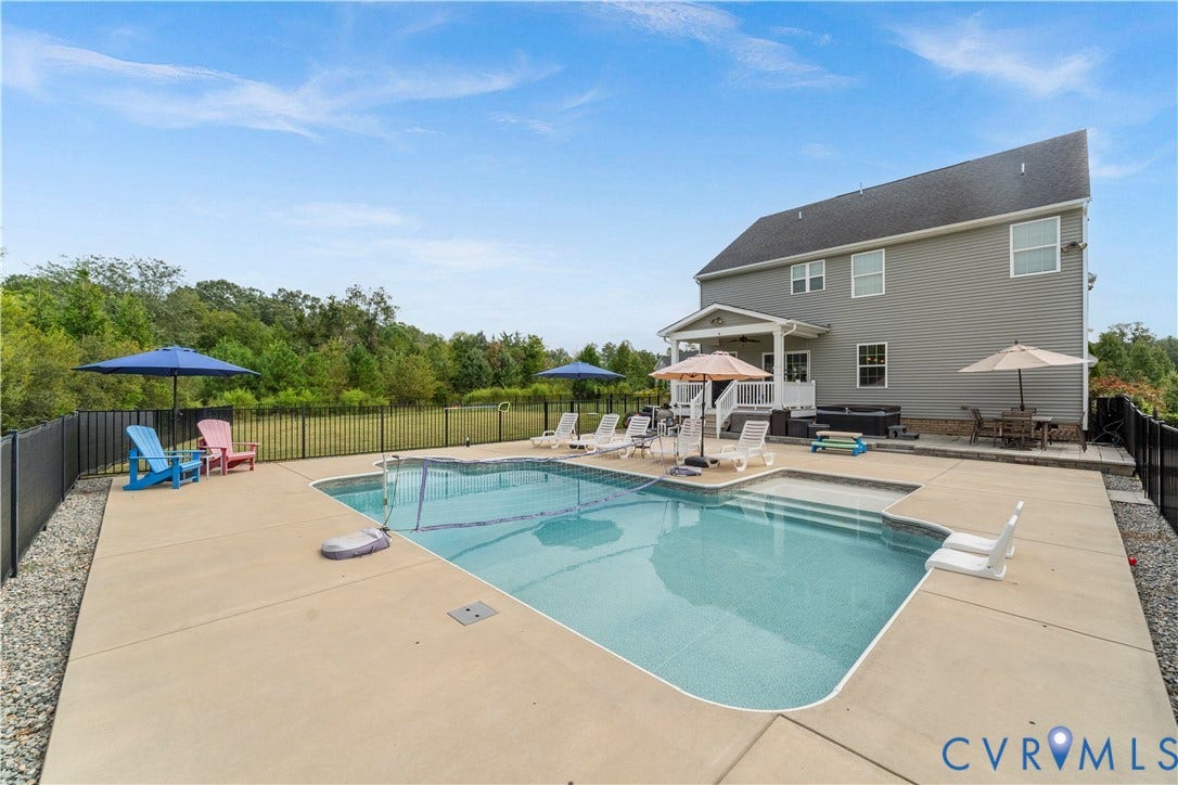 11707 Amara Drive, Chester / Highlands Golf Club, Chesterfield, VA 23838 Swimming pool with integrated steps, concrete patio, rear exterior with covered porch, hot tub, and black metal fencing