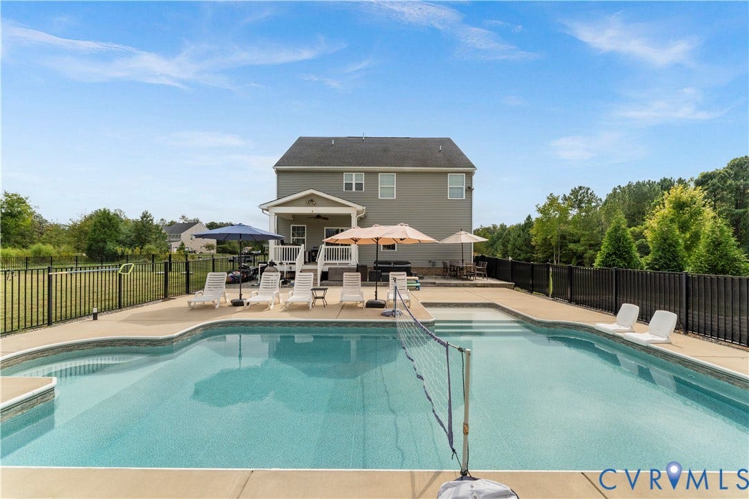 11707 Amara Drive, Chester / Highlands Golf Club, Chesterfield, VA 23838 Expansive backyard featuring a built-in swimming pool, integrated steps, and a surrounding concrete patio