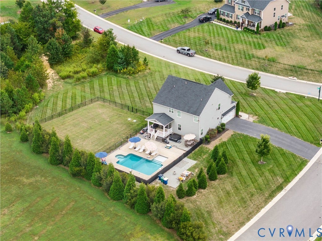 11707 Amara Drive, Chester / Highlands Golf Club, Chesterfield, VA 23838 In-ground swimming pool, expansive paved patio, covered porch, attached two-car garage, and fenced yard