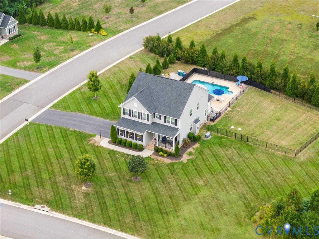 11707 Amara Drive, Chester / Highlands Golf Club, Chesterfield, VA 23838 Two-story residence with a gabled roof, a private swimming pool with concrete surround, and a fenced perimeter