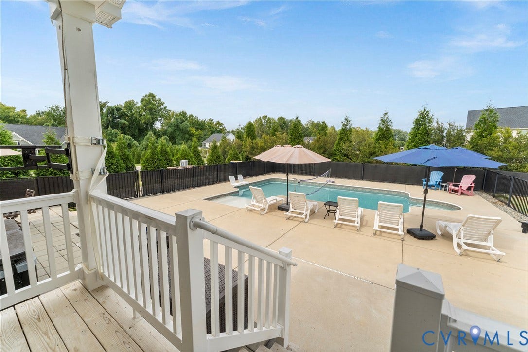 11707 Amara Drive, Chester / Highlands Golf Club, Chesterfield, VA 23838 Outdoor swimming pool with expansive concrete decking, enclosed by a black metal fence