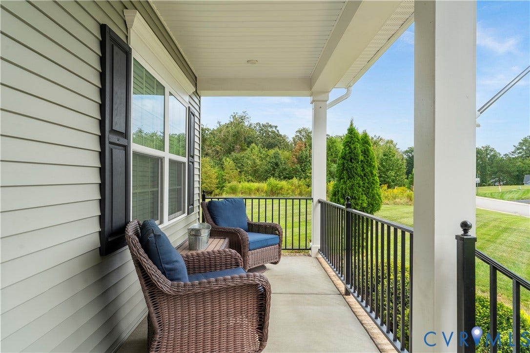 11707 Amara Drive, Chester / Highlands Golf Club, Chesterfield, VA 23838 Covered front porch with concrete flooring, white columns, black railings, and light-colored siding