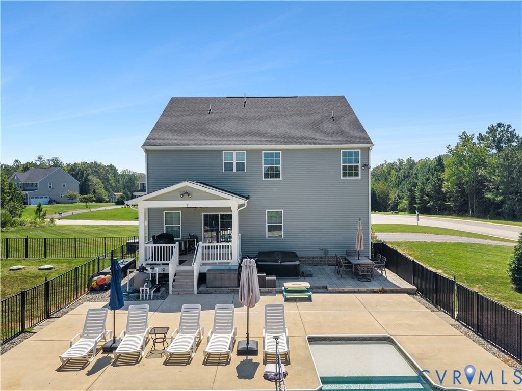 11707 Amara Drive, Chester / Highlands Golf Club, Chesterfield, VA 23838 Expansive rear exterior featuring a covered porch, outdoor patio, in-ground pool, and a fenced yard