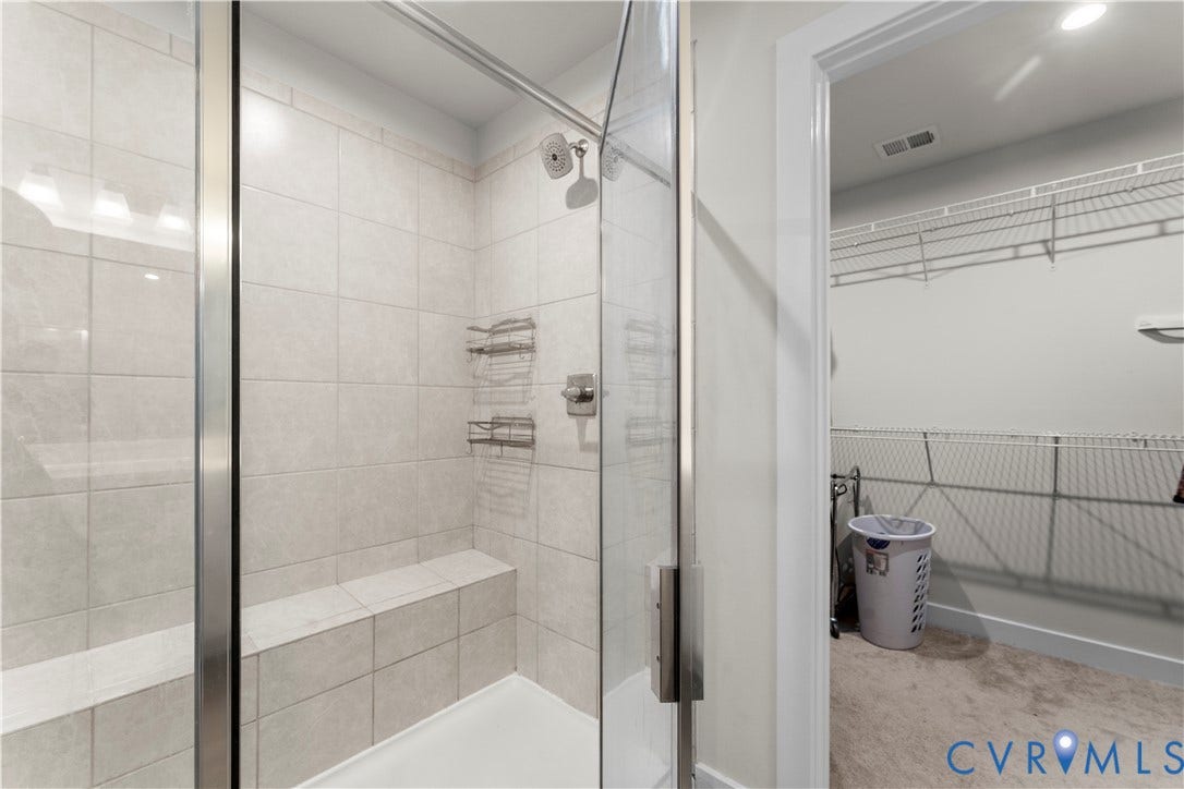 11707 Amara Drive, Chester / Highlands Golf Club, Chesterfield, VA 23838 Shower with a glass enclosure, tile surround, built-in bench, and a brushed nickel showerhead