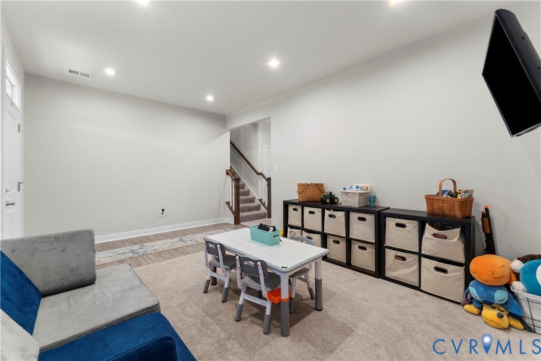 11707 Amara Drive, Chester / Highlands Golf Club, Chesterfield, VA 23838 Recessed lighting illuminates the open area, featuring carpet flooring and wood-finish flooring
