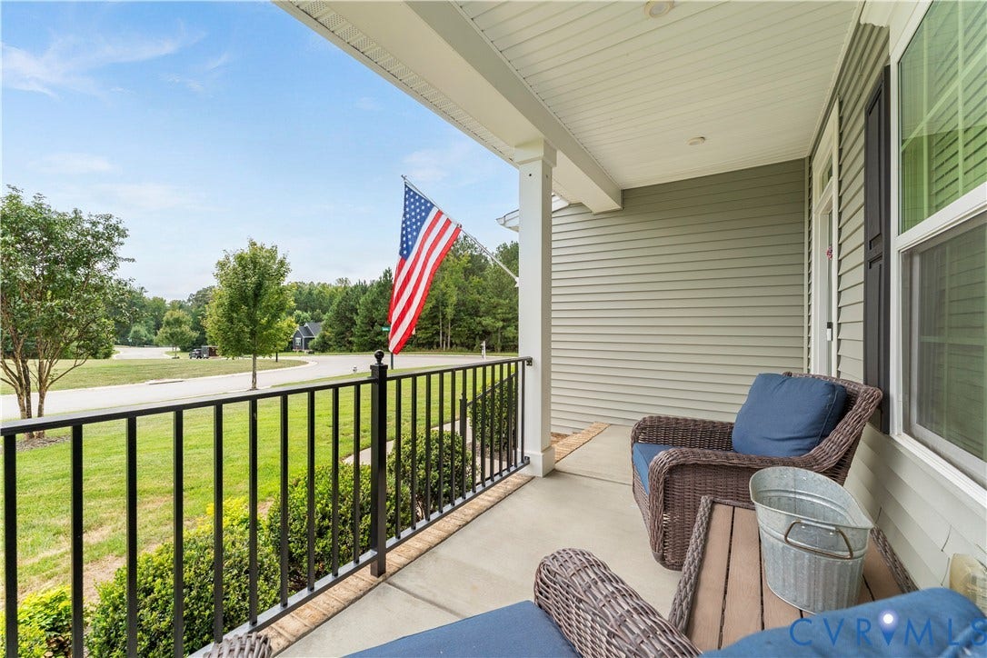 11707 Amara Drive, Chester / Highlands Golf Club, Chesterfield, VA 23838 Covered front porch with concrete flooring, white columns, black railing, and siding exterior