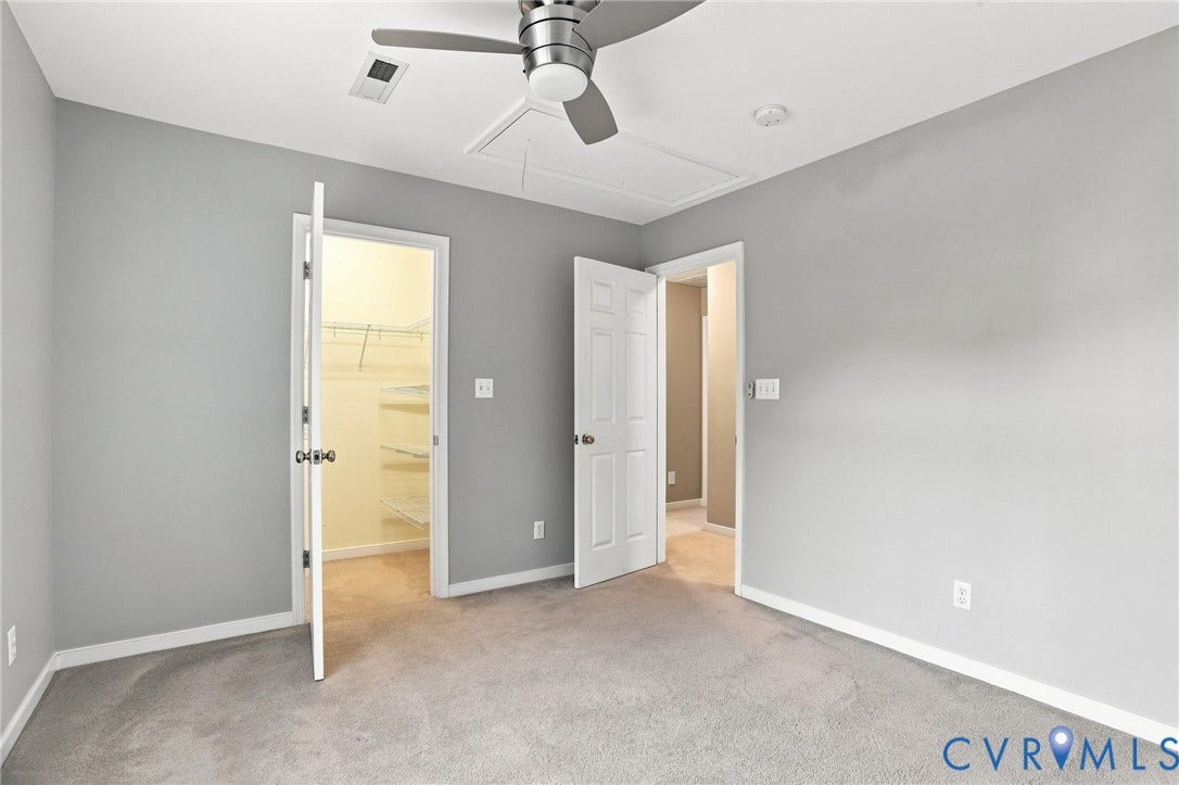 Carpeted room with a ceiling fan, recessed lighting, and two panel doors