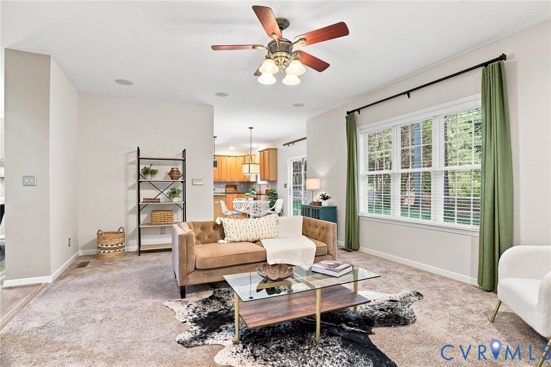 Recessed ceiling lighting, ceiling fan with wood-finish blades, broad window with white blinds, and carpeted flooring