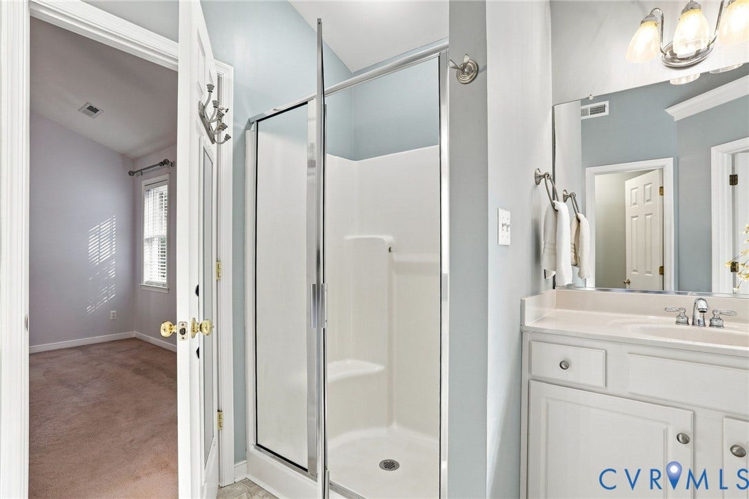 White vanity with an integrated sink and chrome fixtures