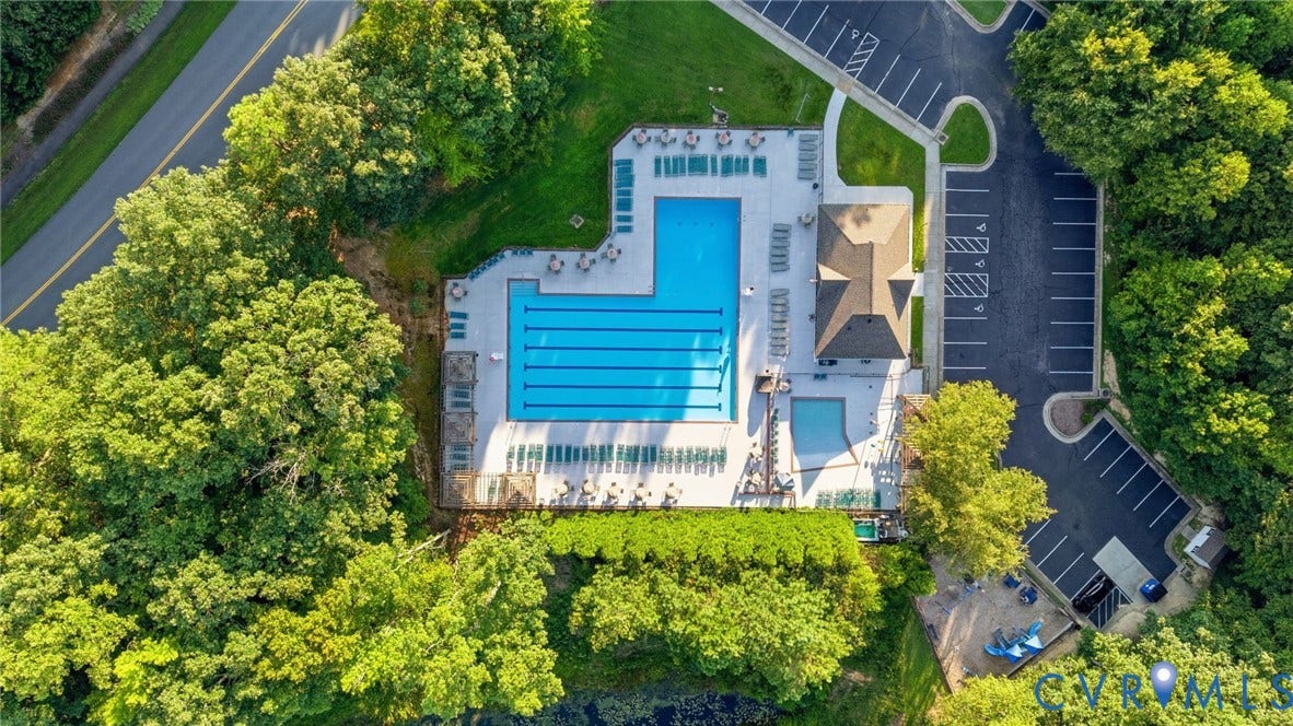 Expansive aquatic facility featuring a lap pool, recreational pool, and surrounding lounge areas