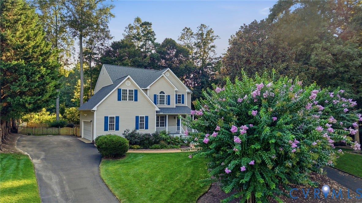 Two-story residence with light-colored siding and blue window shutters
